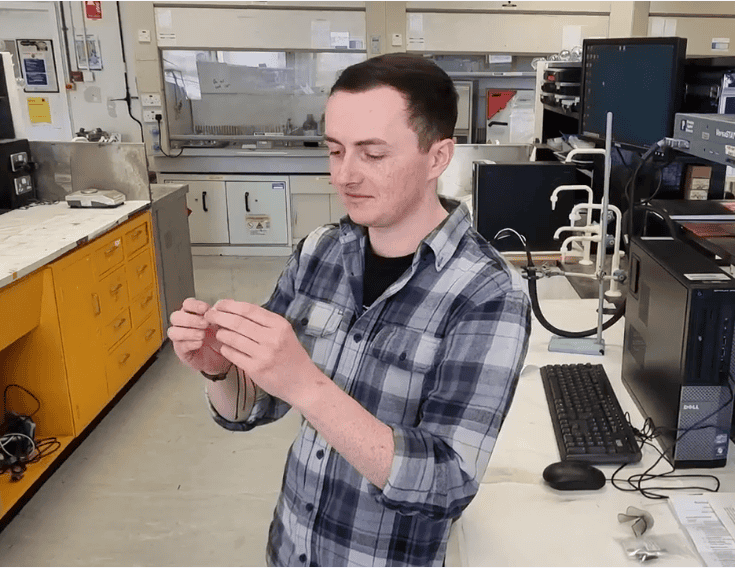 Dr Matthew Ferguson in his lab showing a 3D printed electrode in his hands